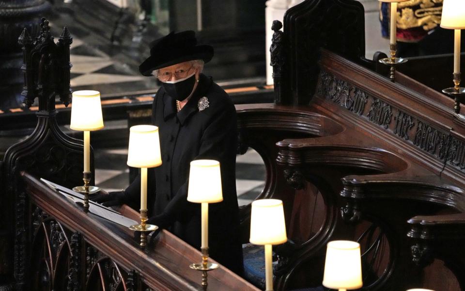 Queen Elizabeth II watches as pallbearers carry the coffin of Prince Philip, Duke Of Edinburgh into St George's Chapel - Getty Images Europe