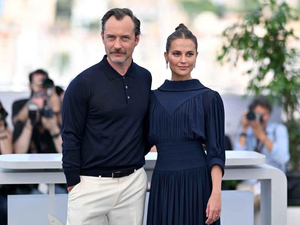Jude Law and Alicia Vikander arm and arm at the 2023 Cannes Film Festival