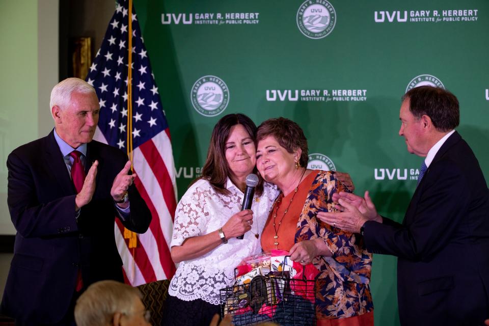 Former Vice President Mike Pence and his wife, Karen Pence, accept a gift from former Gov. Gary Herbert and his wife, Jeanette, at an event at the Zions Bank Building in Salt Lake City on Friday, April 28, 2023. The event was hosted by the Gary R. Herbert Institute for Public Policy at Utah Valley University. | Spenser Heaps, Deseret News