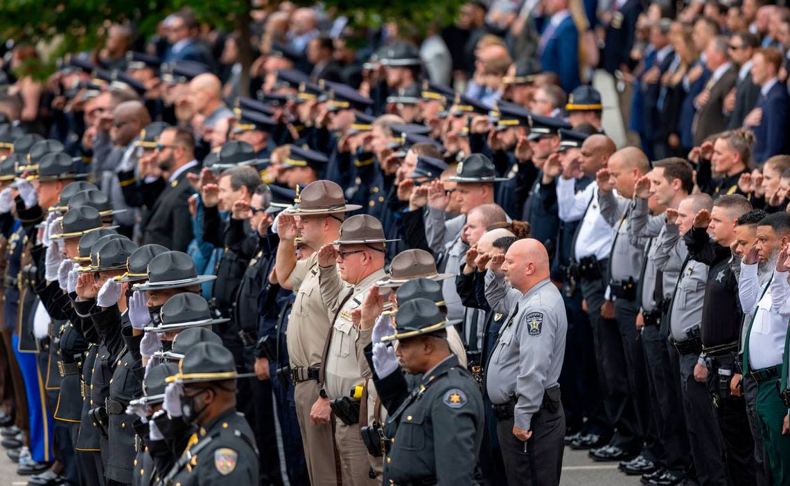 Law enforcement officers from across North Carolina salute as Wake County Deputy Ned Byrdís casket arrives for his funeral at Providence Baptist Church on Friday, August 19, 2022 in Raleigh, N.C.