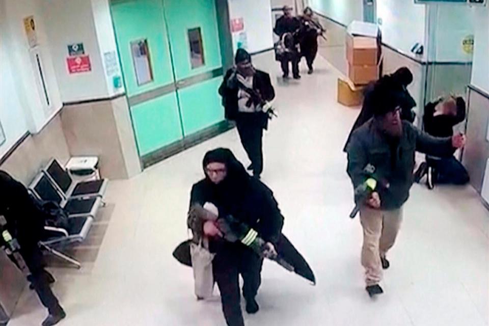 PHOTO: In this image taken from surveillance video provided by the Palestinian Health Ministry, Israeli forces disguised as civilian women and medical workers hold weapons in a hallway at the Ibn Sina Hospital in the West Bank town of Jenin, Jan. 30, 2024 (Palestinian Health Ministry via AP)