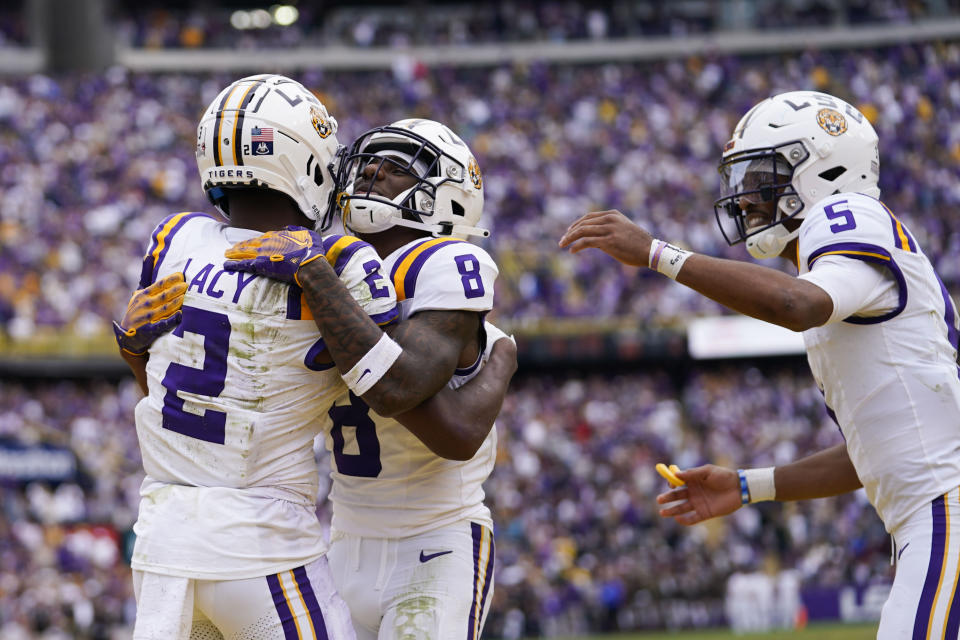 LSU wide receiver Kyren Lacy (2) celebrates his touchdown reception with wide receiver Malik Nabers (8) and quarterback Jayden Daniels (5) in the second half of an NCAA college football game in Baton Rouge, La., Saturday, Nov. 25, 2023. LSU won 42-30. (AP Photo/Gerald Herbert)