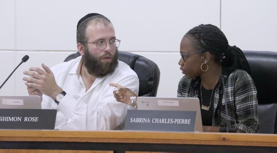 President Shimon Rose talks with Board Member Sabrina Charles-Pierre during a meeting of the East Ramapo School Board at the district administration building in Spring Valley May 2, 2023.