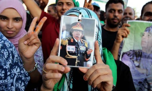 In this picture taken on a guided government tour, supporters of Libyan leader Moamer Kadhafii attend a march in Zawiya. Kadhafi said on Saturday he would never leave the land of his ancestors after fresh international calls for him to go and as rebels pressed their campaign to overthrow him