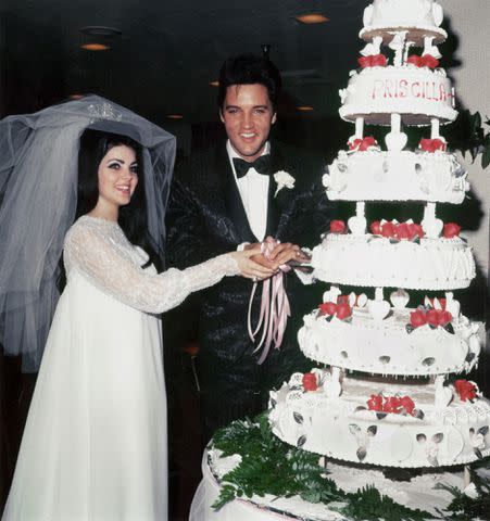 Michael Ochs Archives/Getty Priscilla and Elvis cut their wedding cake in 1967.