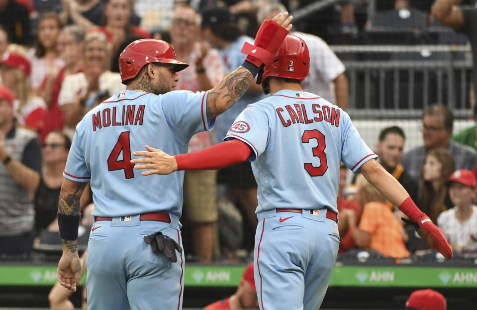St. Louis Cardinals' Yadier Molina (4) and Dylan Carlson greet each other after scoring in the second inning of a baseball game against the Pittsburgh Pirates, Saturday, Aug. 28, 2021, in Pittsburgh, Pa. (AP Photo/Philip G. Pavely)