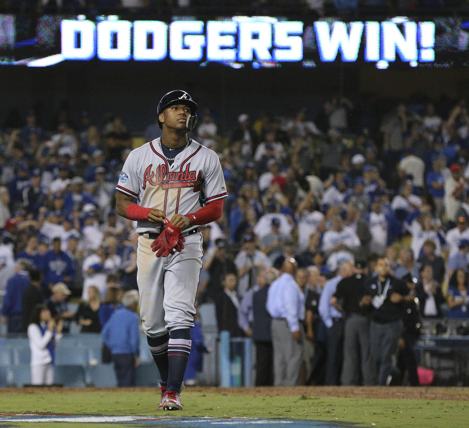 Atlanta Braves base runner Ronald Acuna walks off the field after the final out in a 3-0 loss to the Los Angeles Dodgers in Game 2 of a baseball National League Division Series, Friday, Oct. 5, 2018, in Los Angeles. (Curtis Compton/Atlanta Journal Constitution via AP)