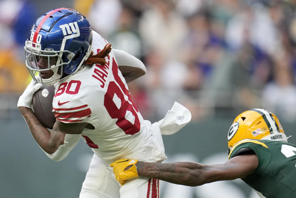 New York Giants wide receiver Richie James (80) is tackled by Green Bay Packers cornerback Rasul Douglas (29) during an NFL game between the New York Giants and the Green Bay Packers at the Tottenham Hotspur stadium in London, Sunday, Oct. 9, 2022. (AP Photo/Kin Cheung)