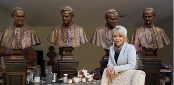 Sculptor Carolyn Palmer and busts of the last four popes who have visited St. Patrick's Cathedral: Pope Francis, Pope Benedict, Pope John Paul and Pope Paul VI. The bronze busts are on display at the New York City cathedral.