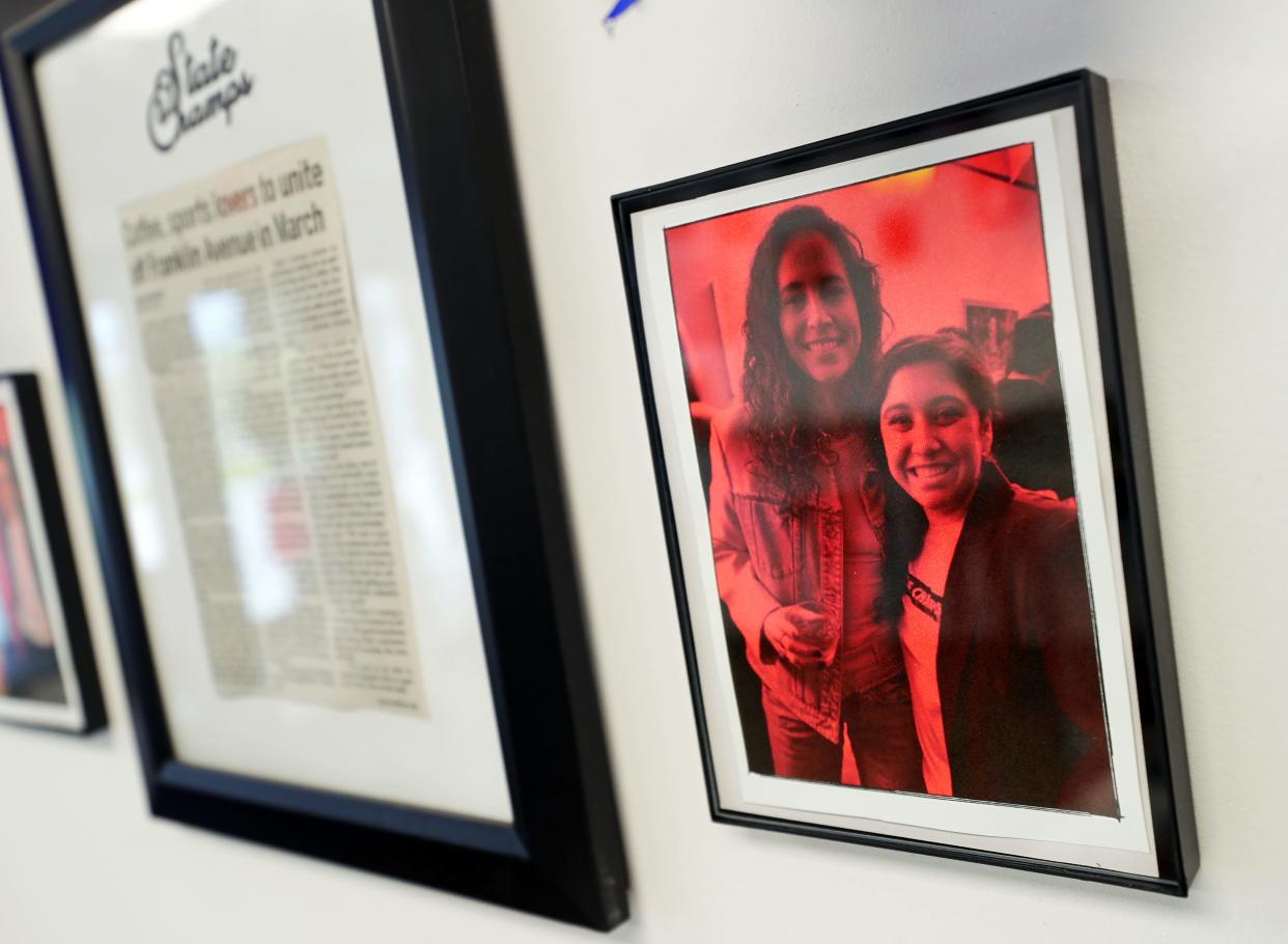 A photograph of Ally Eclarin and former WNBA star Sue Bird during NCAA Women's Final Four festivities in Cleveland is displayed at State Champs.