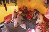 Sikh farmers sit inside their makeshift tent at Singhu, the Delhi-Haryana border camp for protesting farmers against three farm bills, in New Delhi, India, Wednesday, Jan. 27, 2021. Leaders of a protest movement sought Wednesday to distance themselves from a day of violence when thousands of farmers stormed India's historic Red Fort, the most dramatic moment in two months of demonstrations that have grown into a major challenge of Prime Minister Narendra Modi’s government. (AP Photo/Manish Swarup)