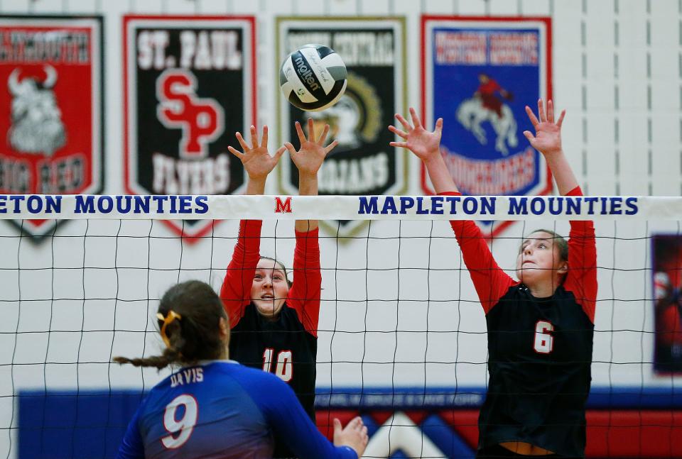 Crestview High School's Callea Shifflet (10) and Izzy Ardis (6) jump to block a shot from Mapleton High School's Bailey Davis (9) Thursday, Sept. 16, 2021. NOELLE BYE/FOR TIMES-GAZETTE.COM