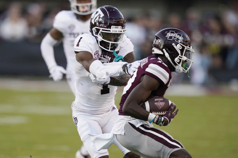 Texas A&M wide receiver Evan Stewart looses a pass as Mississippi State cornerback Emmanuel Forbes reaches in to intercept during the second half of an NCAA college football game against Mississippi State in Starkville, Miss., Saturday, Oct. 1, 2022. Mississippi State won 42-24. (AP Photo/Rogelio V. Solis)