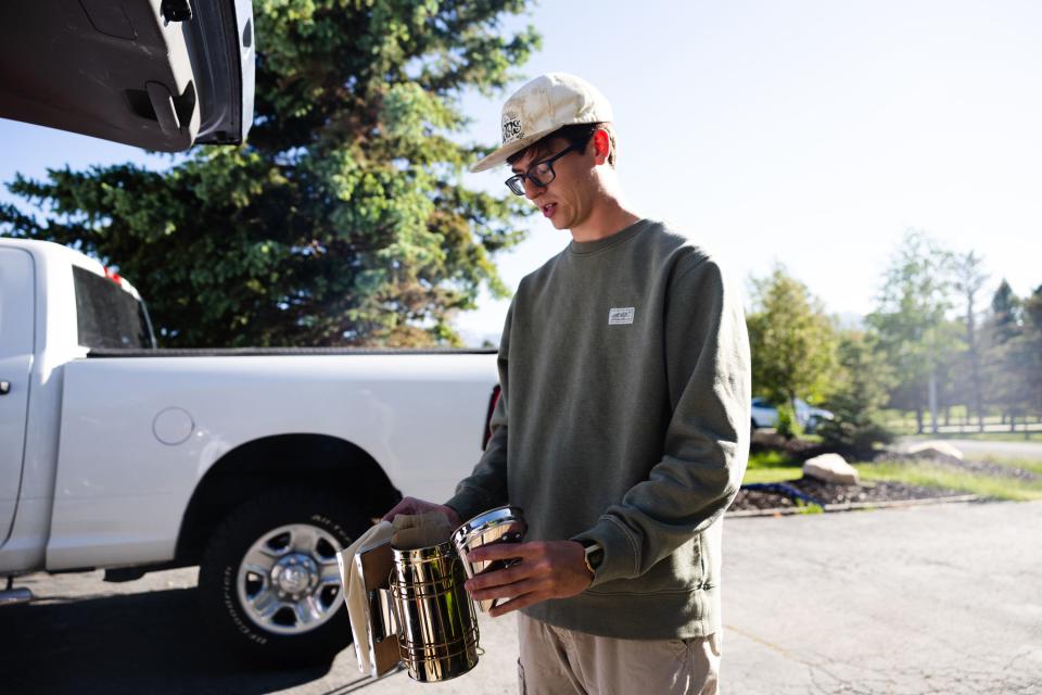 Deseret News features writer Collin Leonard sets up his smoker at his beehive in Park City on June 21, 2023. | Ryan Sun, Deseret News