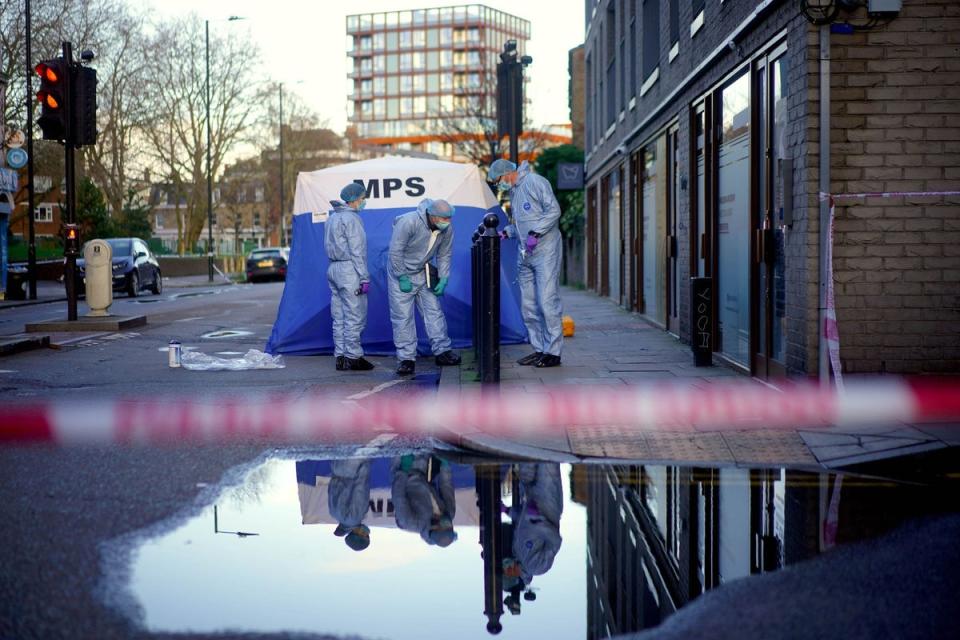 Forensic officers work near to the scene (PA)