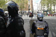 A demonstrator stands in front of riot police officers during a banned protest in support of Palestinians in the Gaza Strip, in Paris, Saturday, May, 15, 2021. Marches in support of Palestinians in the Gaza Strip were being held Saturday in a dozen French cities, but the focus was on Paris where riot police countered organizers who said they would defy a ban on the protest, ordered on the grounds that it risked turning violent. (AP Photo/Rafael Yaghobzadeh)