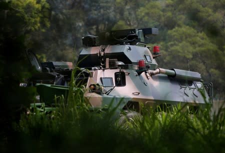 A People's Liberation Army (PLA) armoured personnel carrier manoeuvres in woodland at the PLA's Tam Mei base in Hong Kong's rural New Territories
