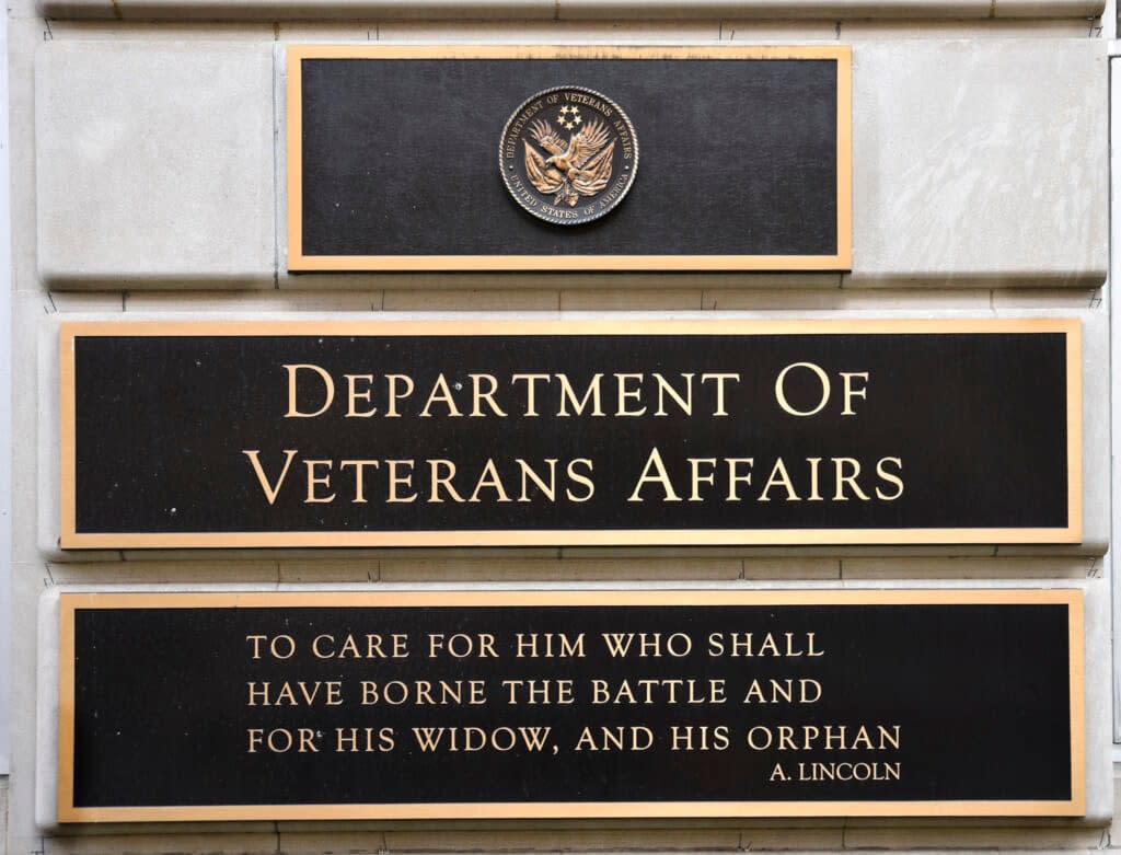 A metal plaque on the facade of the Department of Veterans Affairs building in Washington, D.C., features a quotation by Abraham Lincoln. (Photo by Robert Alexander/Getty Images)