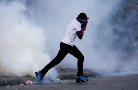 Demonstrators march during a protest to demand the resignation of Haitian president Jovenel Moise, in the streets of Port-au-Prince