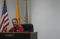 Otero County Commissioner Couy Griffin presides at a public meeting in Alamogordo, N.M., on Thursday, May 13, 2021, in a shirt with a "C4T" logo that stands for Cowboys for Trump. Griffin founded the support group for President Trump that held horseback parades across the country. Griffin is reviled and revered in politically conservative Otero County as he confronts criminal charges for joining protests on the steps of the U.S. Capitol on Jan. 6. He is fighting for his political future amid a recall initiative and state probes into his finances. (AP Photo/Morgan Lee)