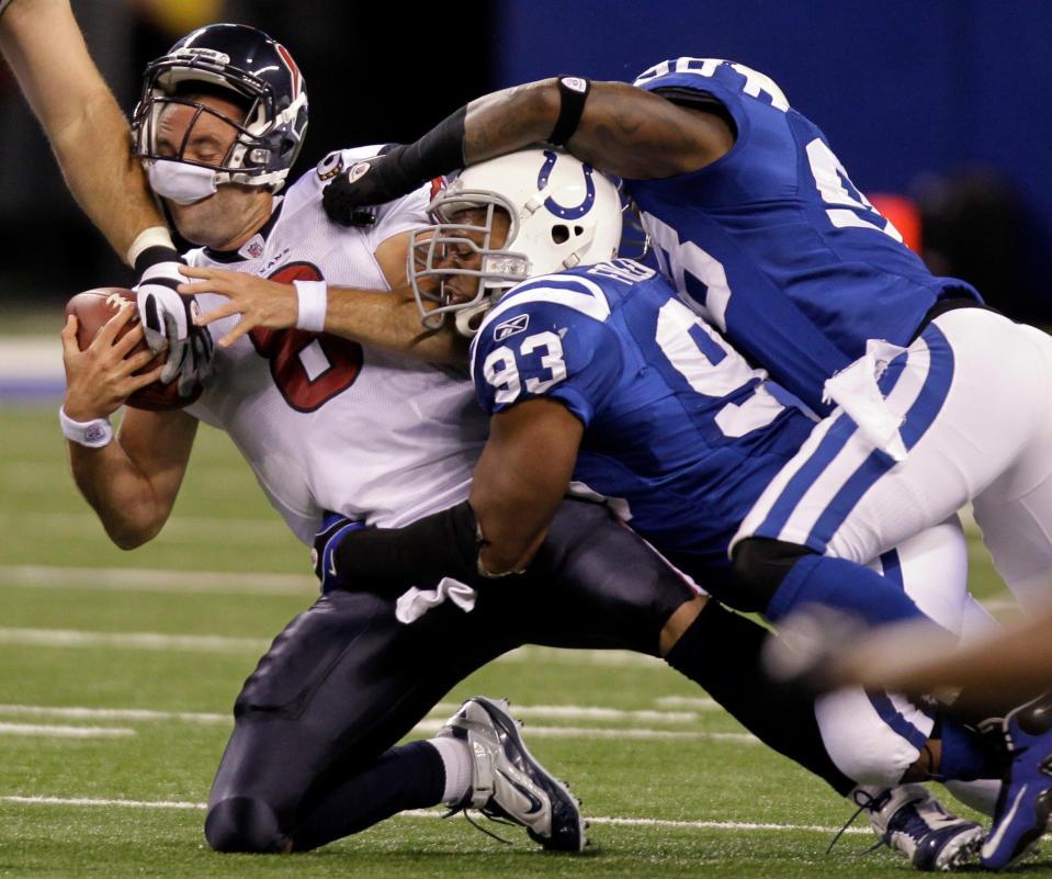 Houston Texans quarterback Matt Schaub, left, is sacked by Indianapolis Colts' Dwight Freeney (93) and Robert Mathis in the first quarter of an NFL football game in Indianapolis, Monday, Nov. 1, 2010. (AP Photo/Michael Conroy)