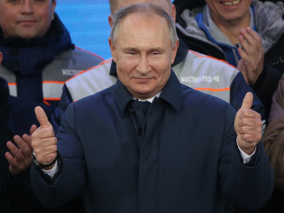 Russian President Vladimir Putin smiling with two thumbs up.