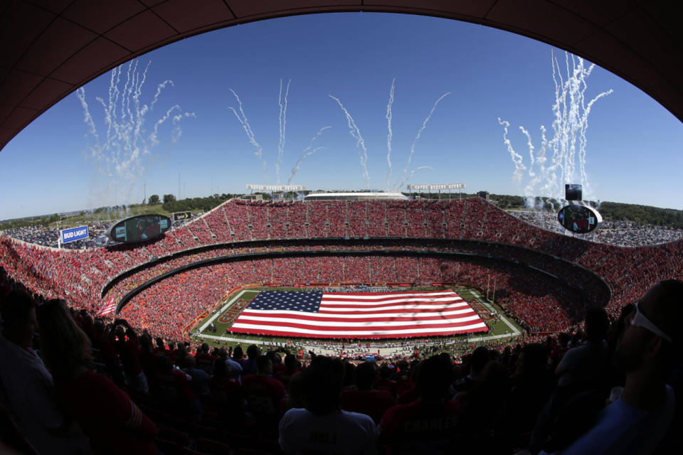 A giant flag is spread over the field at Arrowhead Stadium