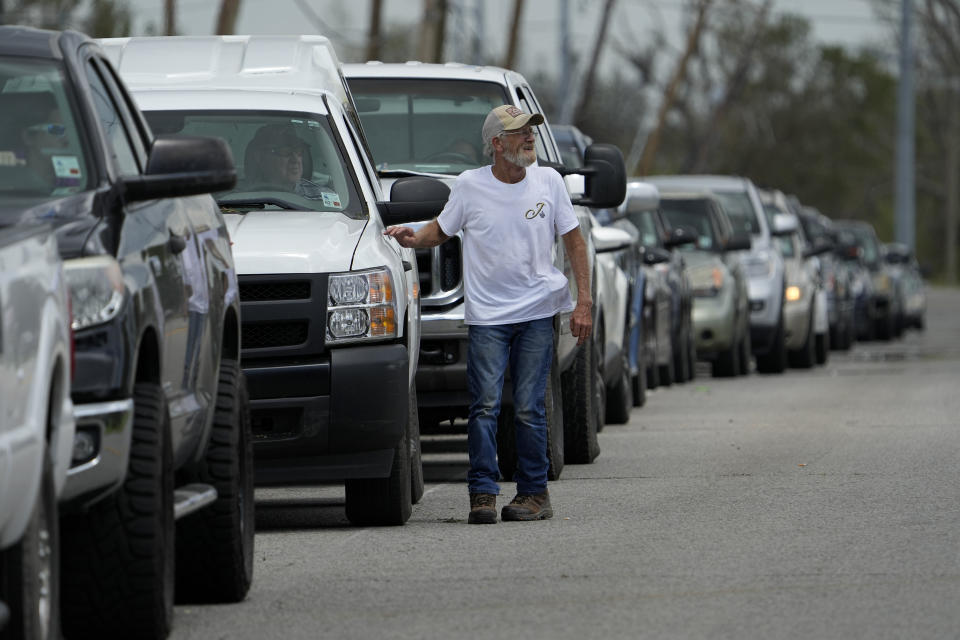 In the aftermath of Hurricane Ida, cars line up up for gas Tuesday, Aug. 31, 2021, in Houma, La. (AP Photo/David J. Phillip)