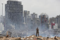 A soldier stands at the devastated site of the explosion in the port of Beirut, Lebanon, Thursday, Aug. 6, 2020. French President Emmanuel Macron came in Beirut to offer French support to Lebanon after the deadly port blast. (AP Photo/Thibault Camus, Pool)