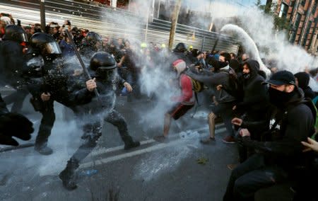 FILE PHOTO: Mossos d'Esquadra police officers and protesters from Committees for the Defence of the Republic (CDR) clash during a demonstration against Jusapol Foundation rally in Barcelona, Spain November 10, 2018. REUTERS/Albert Gea