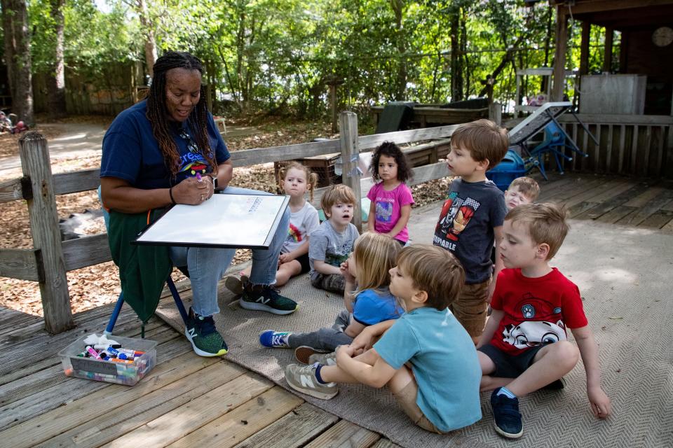 Sandy Pleas teaches children about counting while outdoors at Creative Preschool on Tuesday, April 25, 2023.