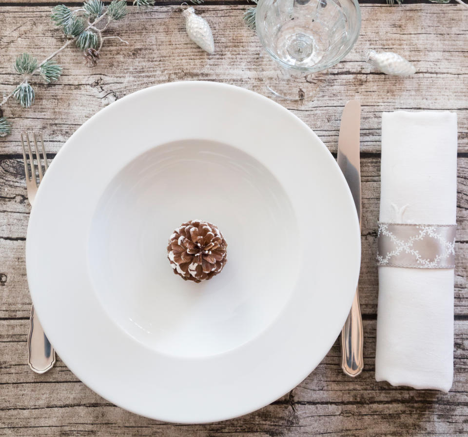 <p>Start by setting the table a day or so early. Use a bar cart to transport all of your dishes into the dining room and leave it there for quick removal of dirty dishes post-meal (just one trip each way!). While the utensils are out of the drawer, take that time to clean inside where crumbs have collected.</p> <p>Put the utensil caddy in the top rack of the dishwasher (or wipe it down with a rag dipped in warm, soapy water), then use a lint roller to pick up crumbs. To access crumbs in the corner of the drawer, tear off a piece of the sticky paper and wrap it around a butter knife.</p>