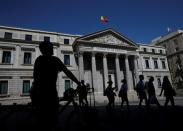 People walk past Spain's parliament in Madrid, Spain, August 28, 2016. REUTERS/Andrea Comas