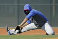 Texas Rangers' Elvis Andrus fields a ball during spring training baseball practice Monday, Feb. 17, 2020, in Surprise, Ariz. (AP Photo/Charlie Riedel)