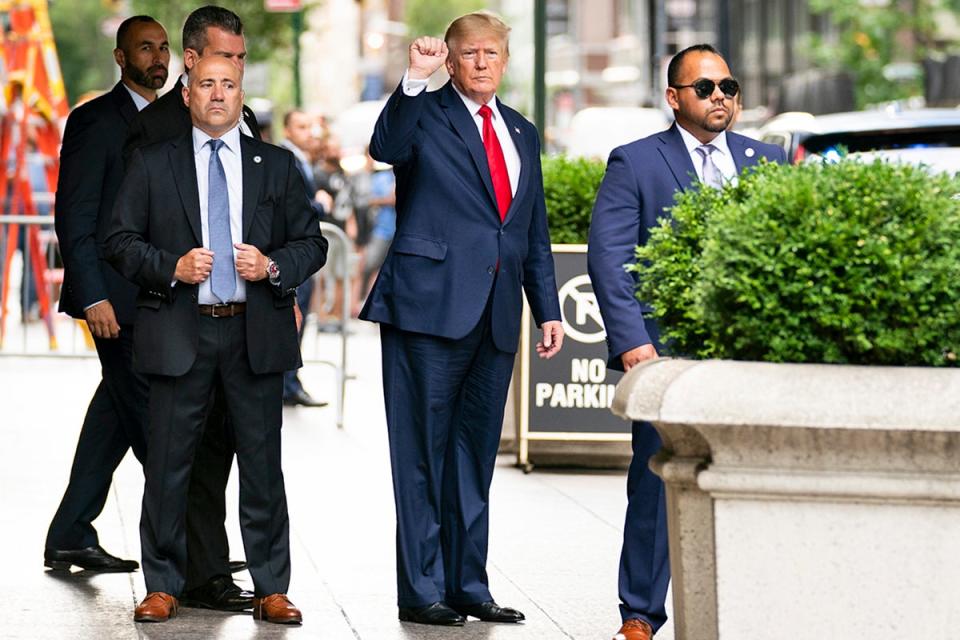 Former President Donald Trump gestures as he departs Trump Tower on his way to deposition (AP)