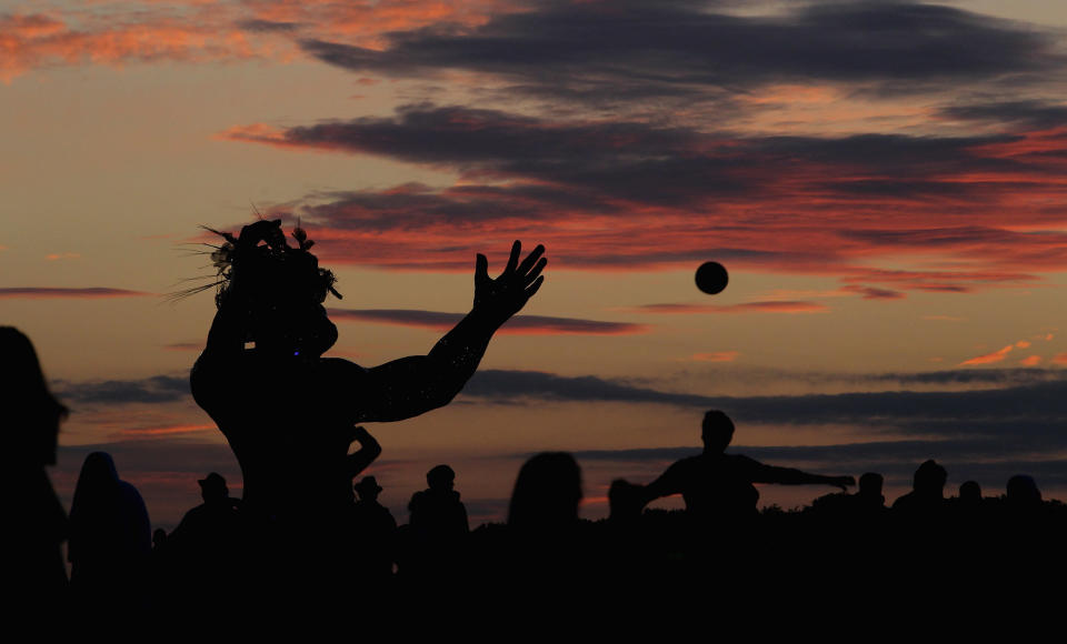 AMESBURY, ENGLAND - JUNE 20:  Solstice participants wait for the midsummer sun to rise over the megalithic monument of Stonehenge on June 20, 2010 on the edge of Salisbury Plain, west of Amesbury, England. (Photo by Matt Cardy/Getty Images)