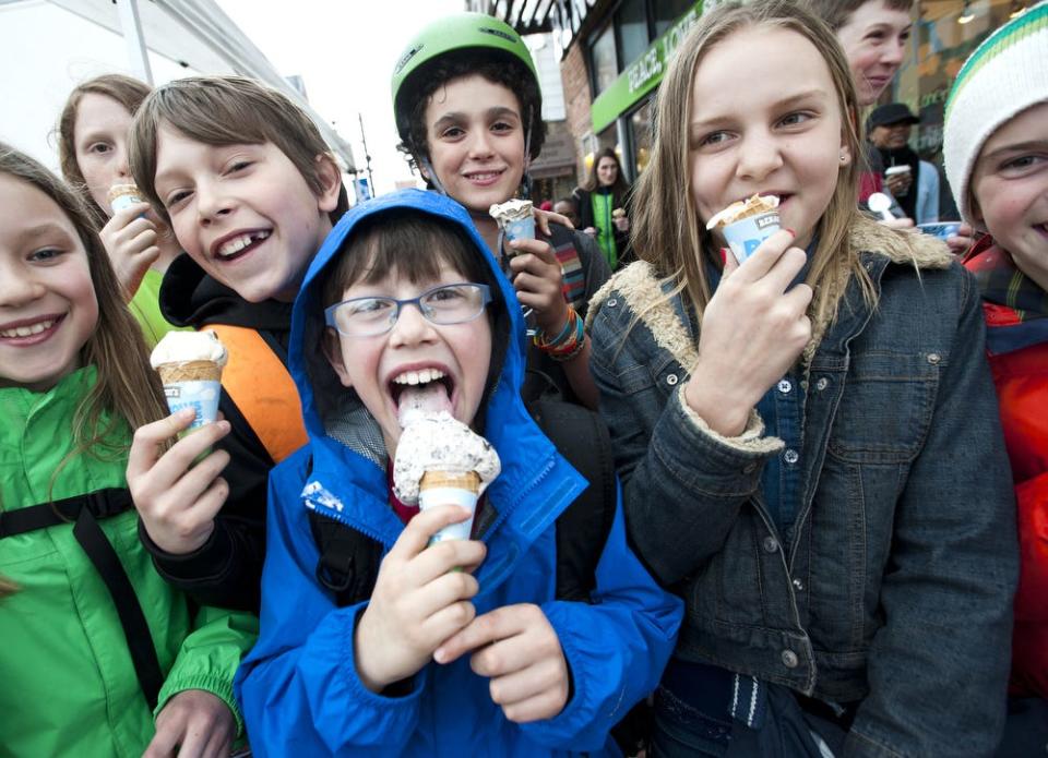 From left, Ana Sealy, Ethan Vincent, Jake Manley, Joey Manley, Harrison Diebold, Ivy Ankerson and Ruby Wool are all smiles with their free ice cream cones during Ben and Jerry's Free Cone Day on Tuesday April 8, 2014.