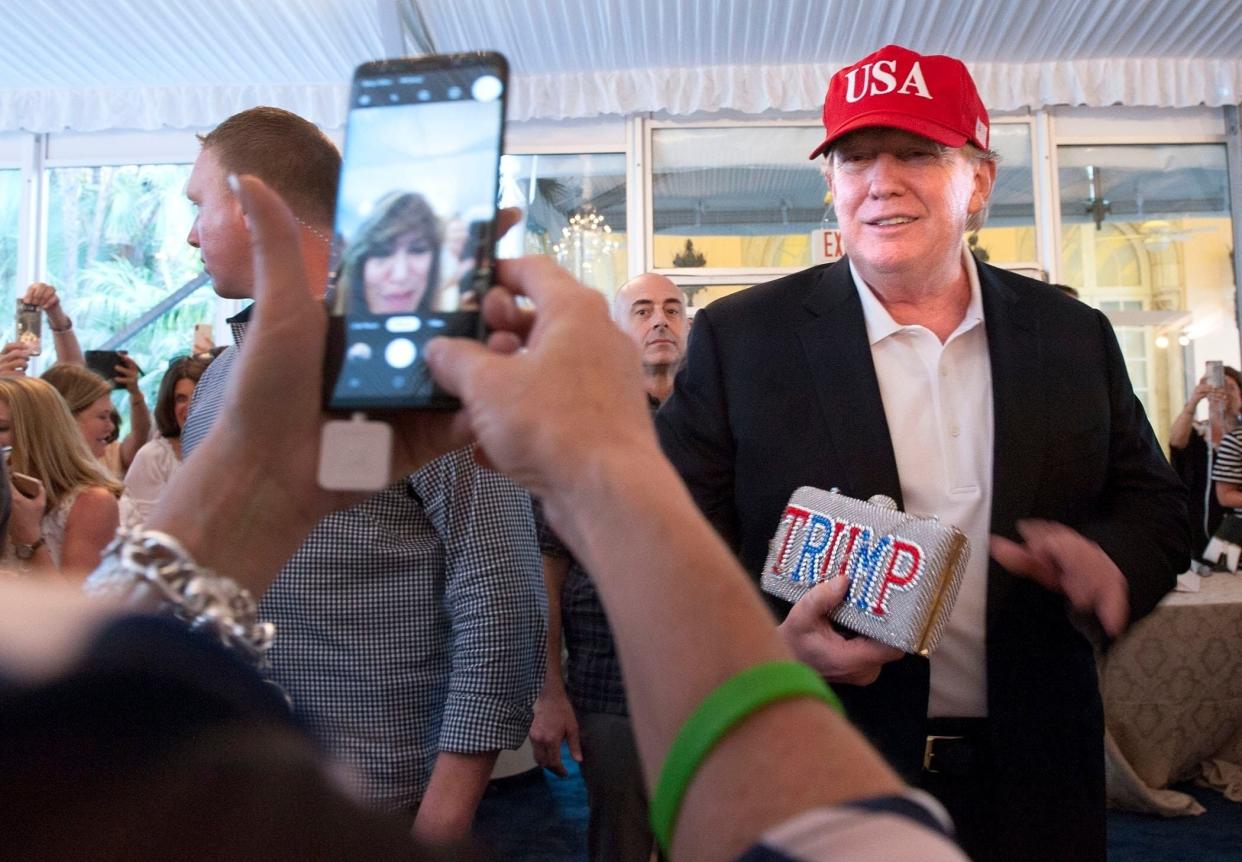 Then-President Donald Trump stops at Big Dog Ranch Rescue's 6th annual Wine, Women and Shoes Lunch and Fashion Show at Mar-a-Lago on March 9, 2019.