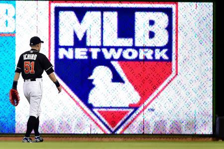 Jul 26, 2016; Miami, FL, USA; Miami Marlins center fielder Ichiro Suzuki (51) walks past the MLB sign during the fifth inning against the Philadelphia Phillies at Marlins Park. Mandatory Credit: Steve Mitchell-USA TODAY Sports