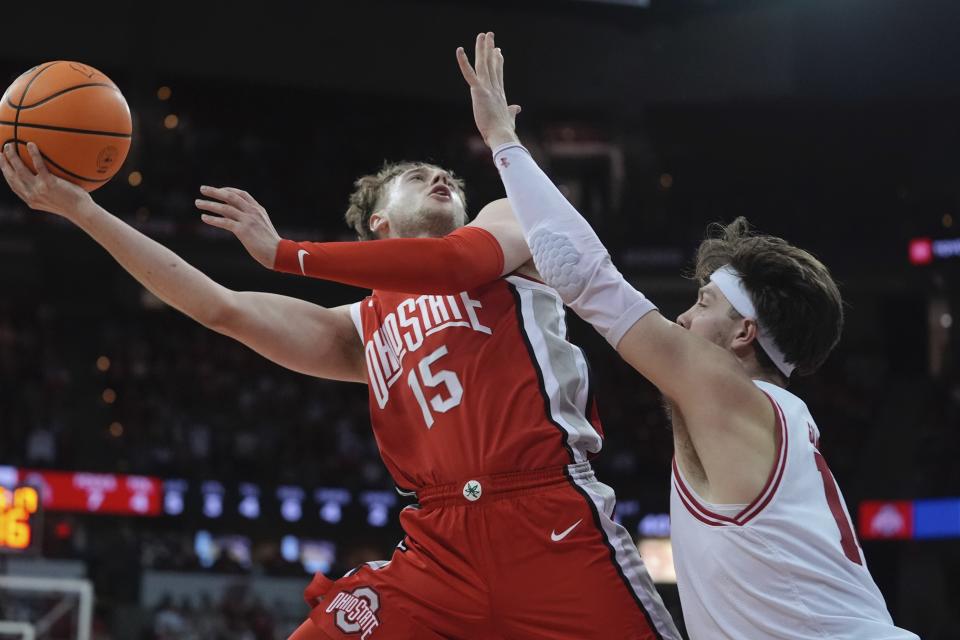 Ohio State's Bowen Hardman shoots past Wisconsin's Carter Gilmore during the first half of an NCAA college basketball game Tuesday, Feb. 13, 2024, in Madison, Wis. (AP Photo/Morry Gash)