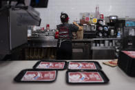 Part-time employee Adriana Ruiz, 18, works on an order in the kitchen at a Wendy's restaurant owned by Lawrence Cheng and his family in Fountain Valley, Calif., June 20, 2024. California's minimum wage increase that went into effect in April and saw fast food workers across the state go from making $16 to $20 overnight is already having an impact on local operators who say they are reducing worker hours and raising menu prices as the sudden increase in labor costs leaves them scrambling for solutions. (AP Photo/Jae C. Hong)