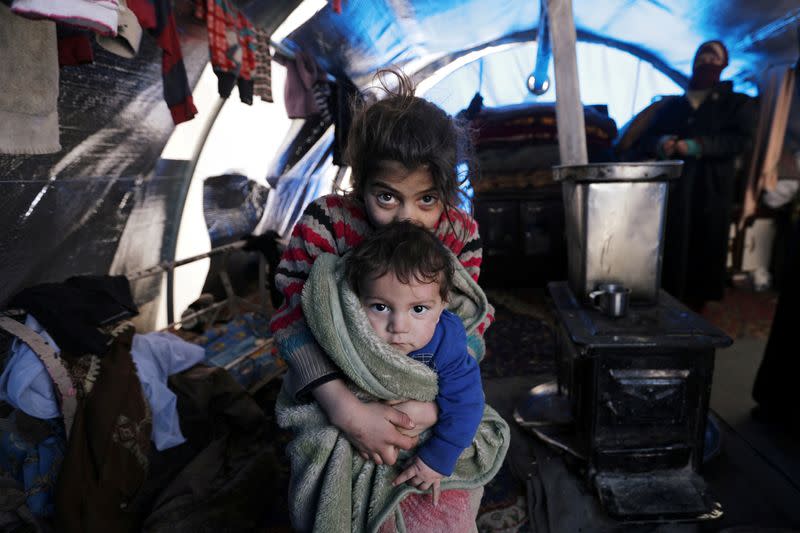 FILE PHOTO: Internally displaced children sit inside a tent in Afrin