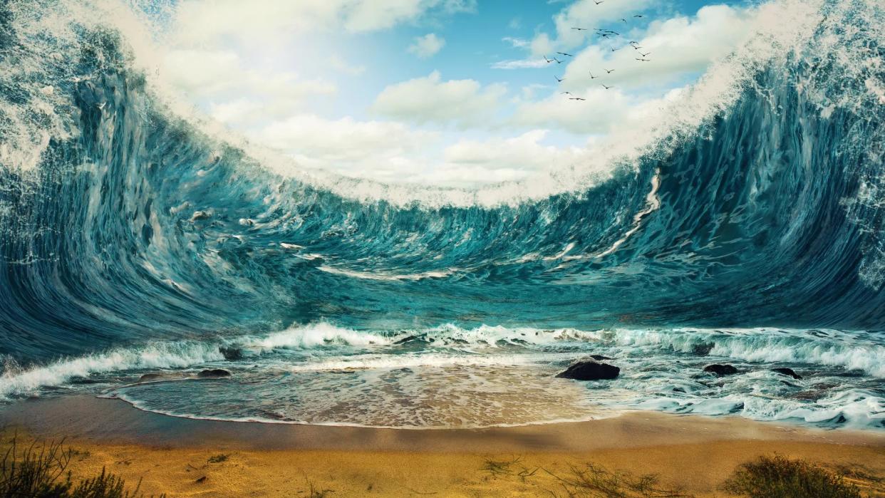  An artist's illustration of a tsunami wave poised to crash down upon a beach.  