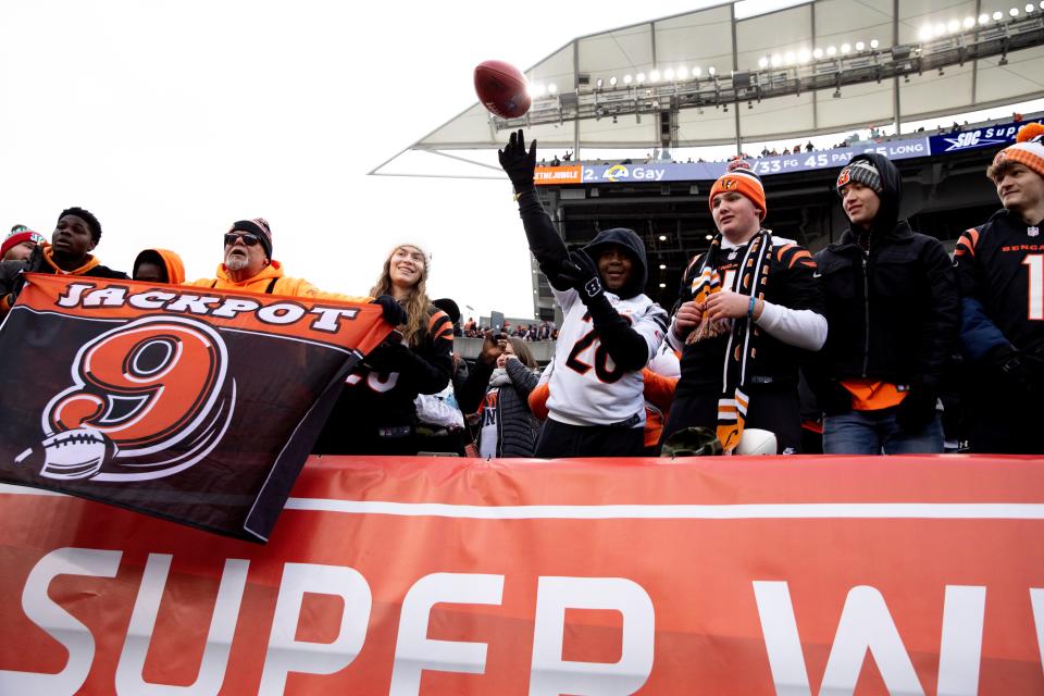 Cincinnati Bengals fan throws a ball back to running back Chris Evans (25) before the AFC wild-card game with Las Vegas Saturday, Jan. 15.