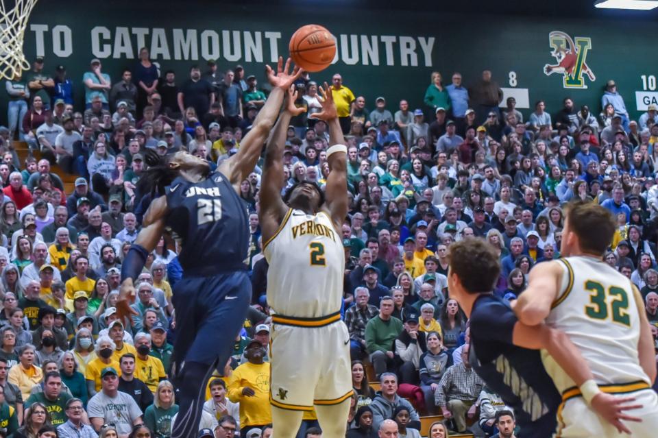 Vermont's Sam Alamutu and New Hampshire's Clarence Daniels battle for a rebound late in the second half in Tuesday's America East semifinal at Patrick Gym in Burlington, Vermont.