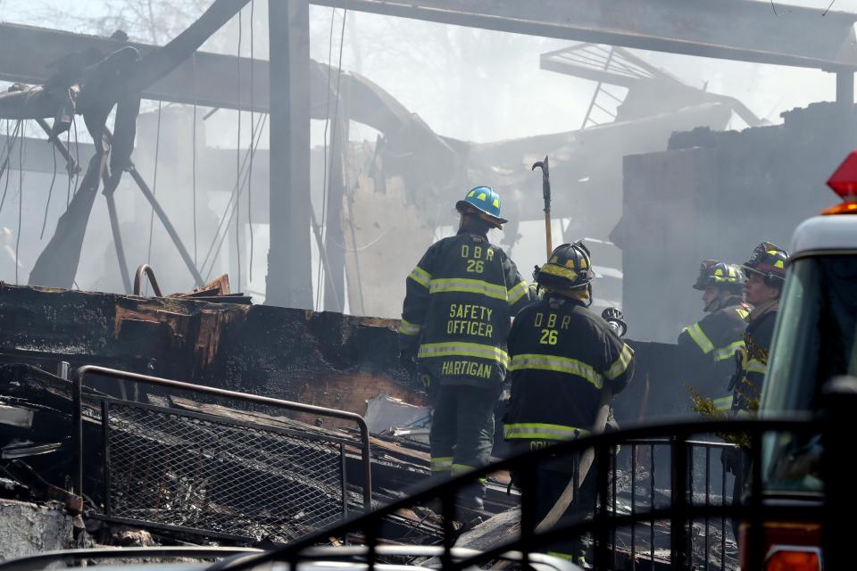 Firefighters work at the scene of a major fire at the Evergreen Court Home for Adults in Spring Valley March 23, 2021.