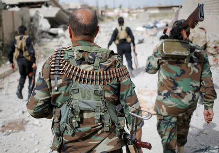 Kurdish Peshmerga fighters search for Islamic State militants in Tel Asqof, northern Iraq May 4, 2016. REUTERS/Goran Tomasevic