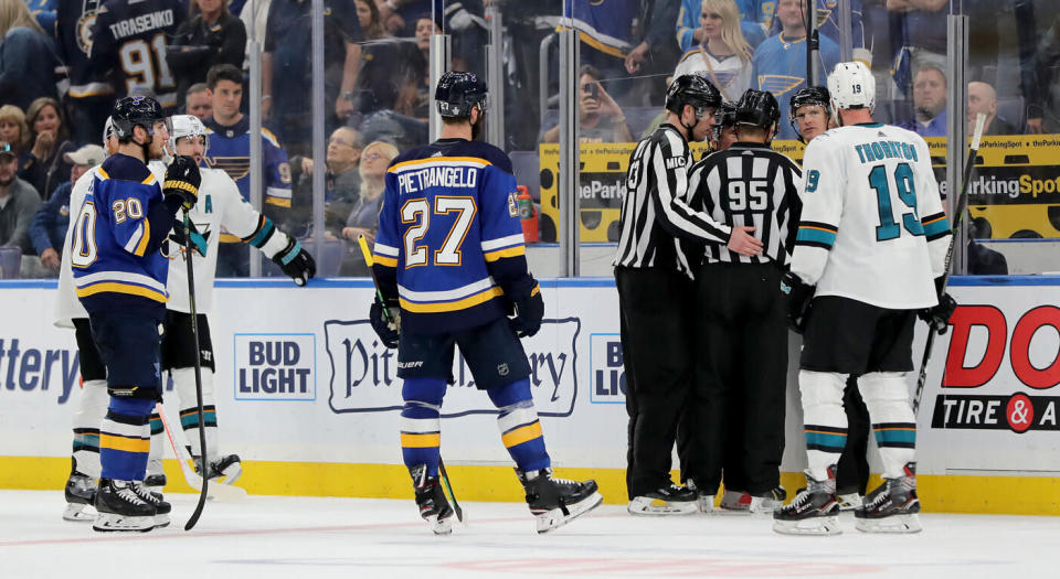 Referees huddle up after the controversial goal. (Getty)