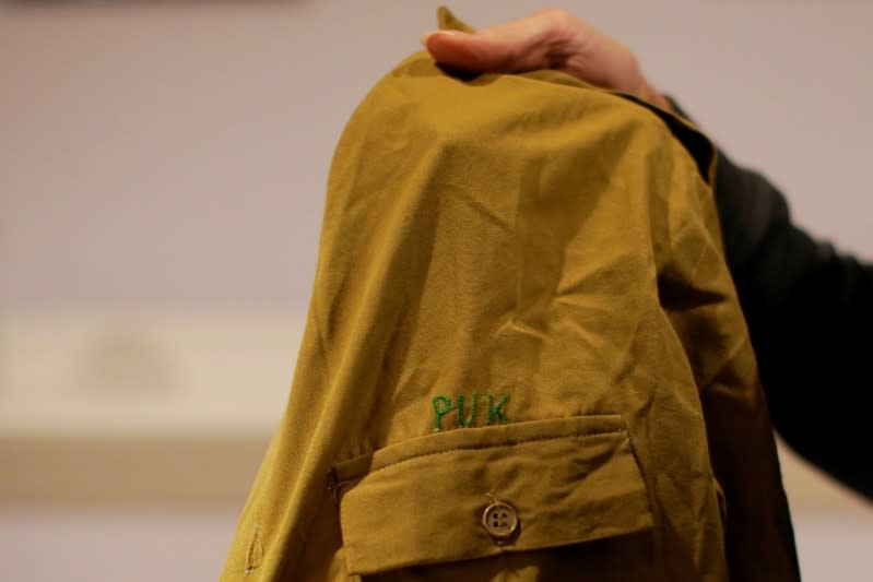 Mark Giaconia, who served for 20 years in the U.S. Army, of which 15 years in the U.S. Special Forces and was embedded with the Kurds in Iraq, holds his Patriotic Union of Kurdistan (PUK) uniform at his house in Herndon