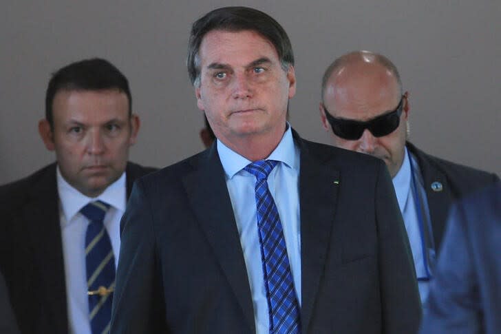 FILE PHOTO: Brazil's President Jair Bolsonaro walks after a meeting at the Ministry of Defense headquarters, amid the coronavirus disease (COVID-19) outbreak, in Brasilia